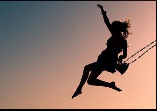 woman jumping from swing